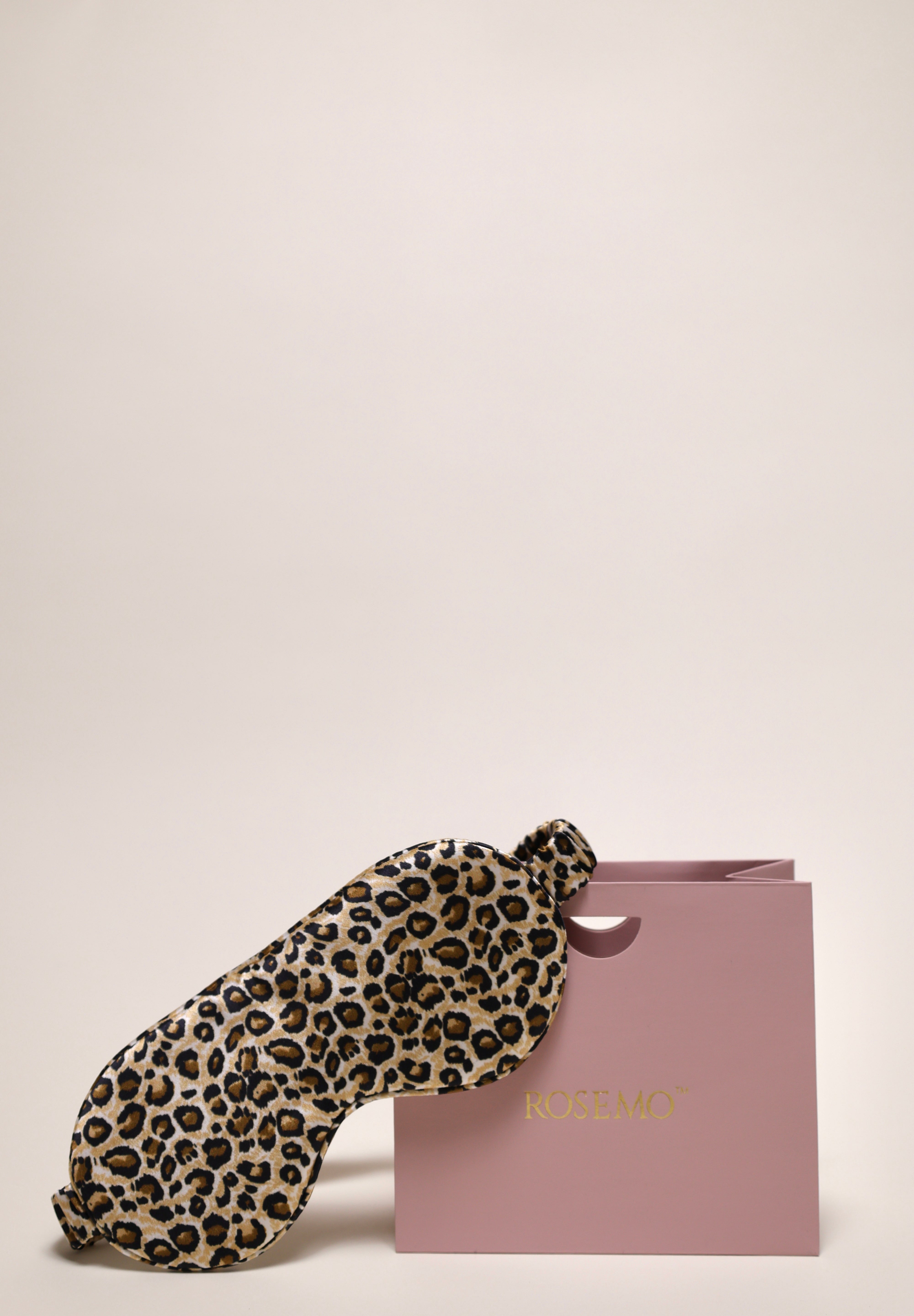 Leopard print silk eye mask next to a ROSEMO pink gift box 