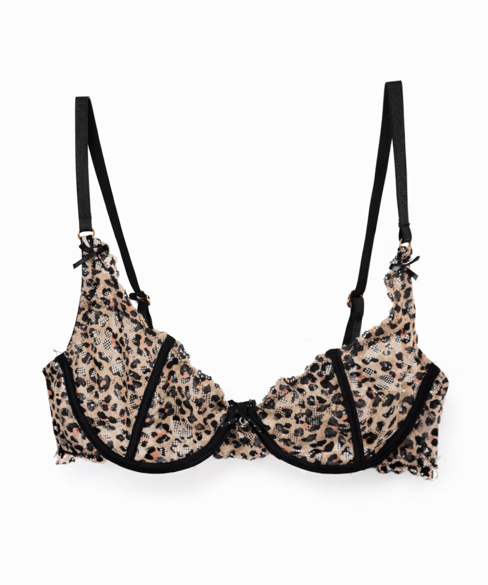 Leopard print lace bra with black bow straps on a white background