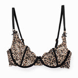 Leopard print lace bra with black bow straps on a white background