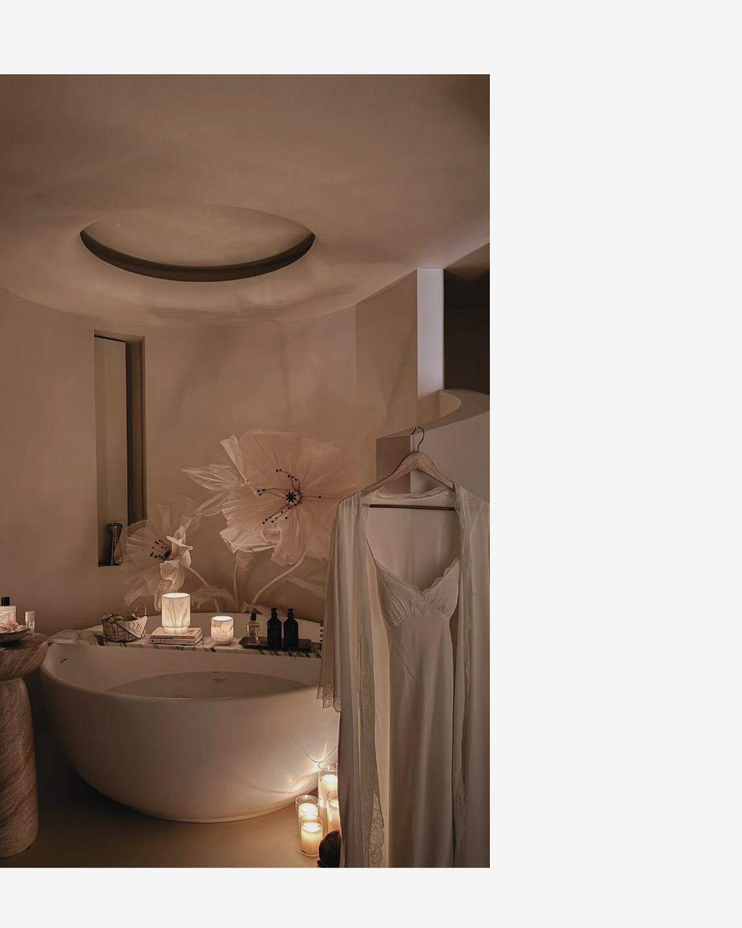 Bathroom interior with a sink, mirror, and hanging robe.