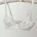 White bra on a hanger against a white background