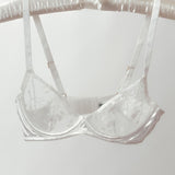 White bra on a hanger against a white background