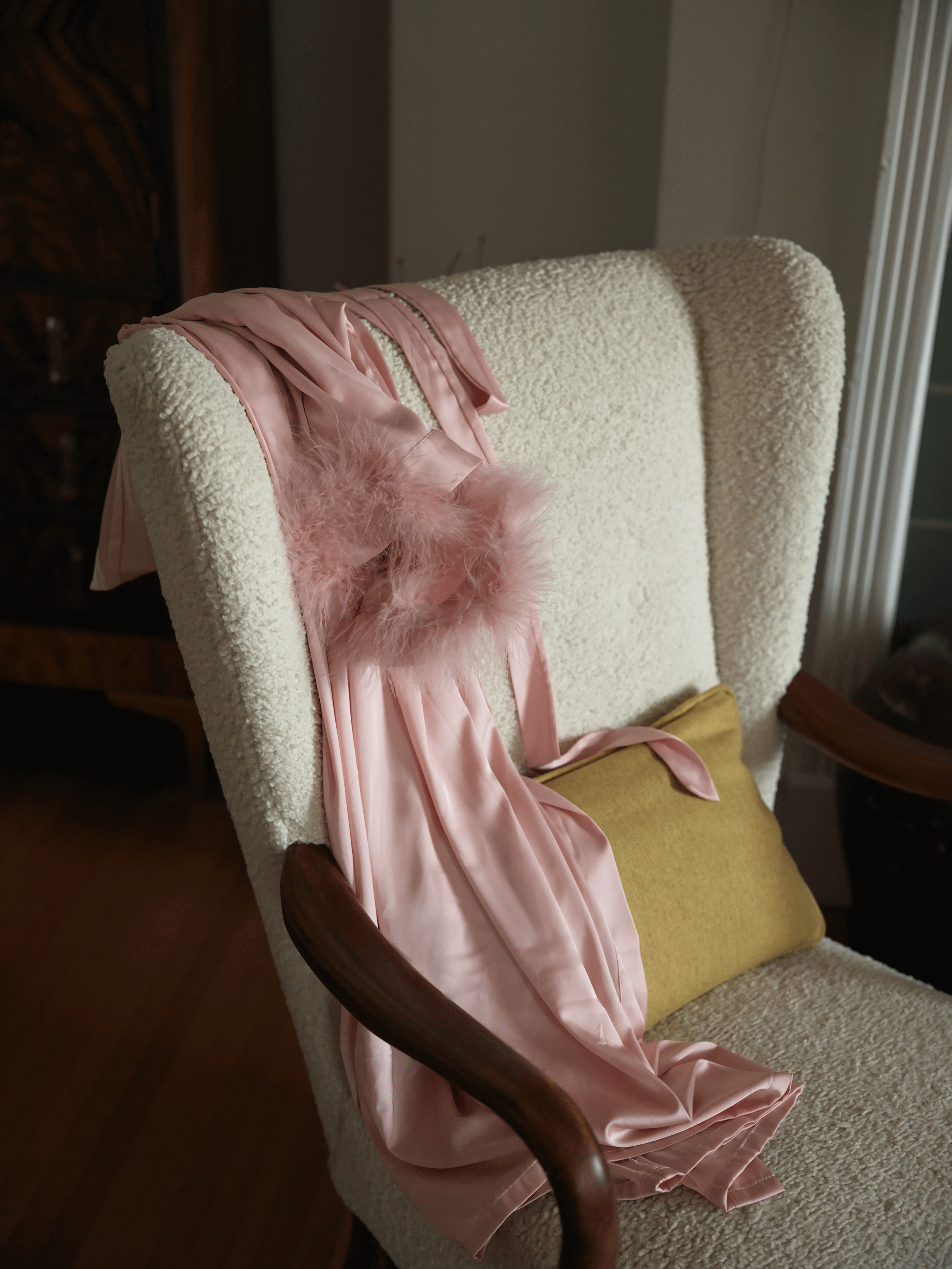 Pink satin lingerie robes on a couch