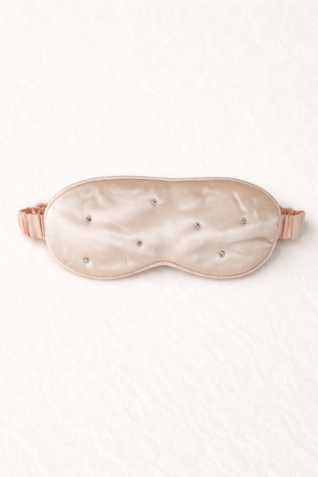 Silk sleep mask with rhinestone embellishments on a white background
