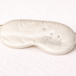 Silk sleep mask with 'Bride' embroidery on a white background
