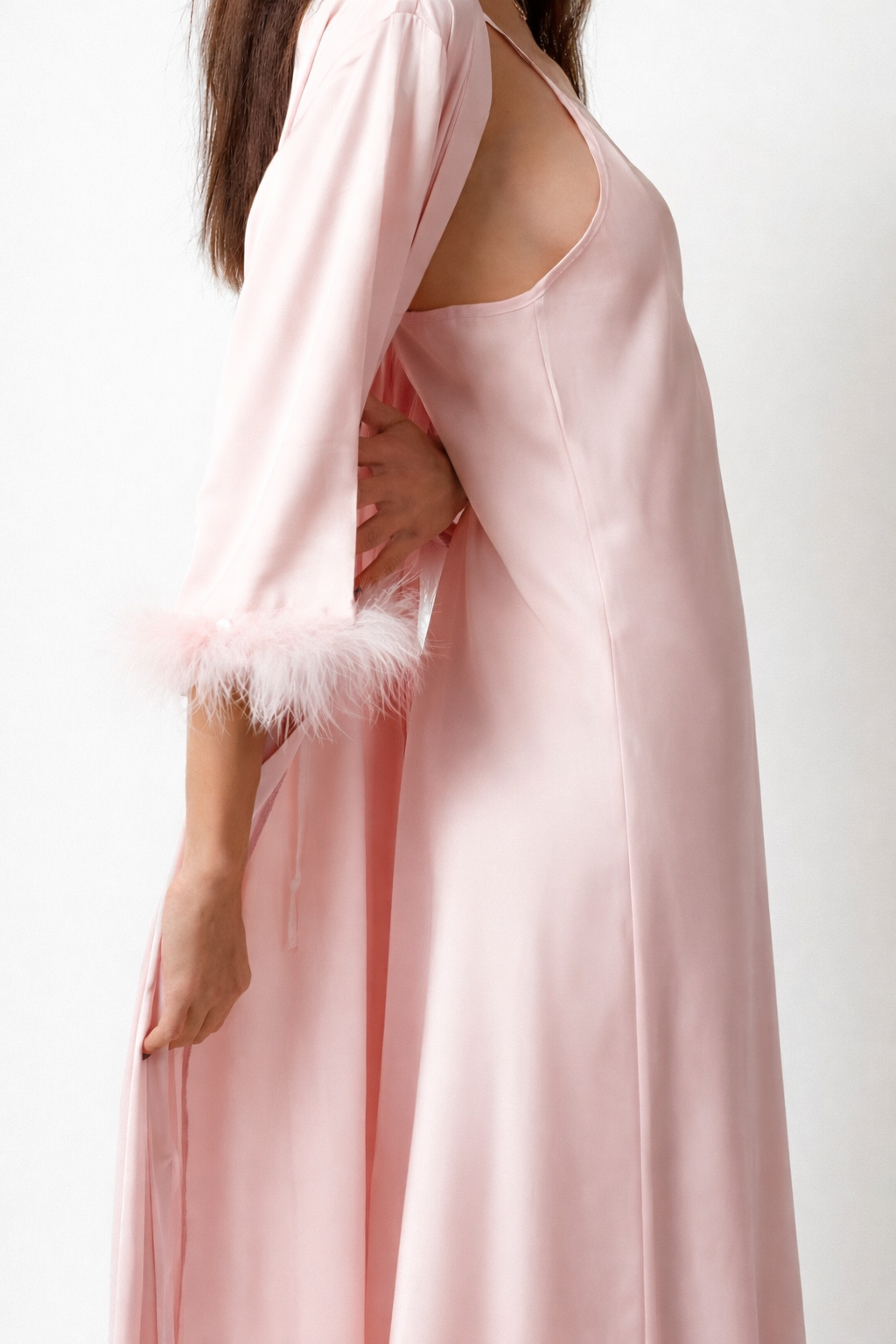 Pink satin robe with feathered trim on a white background