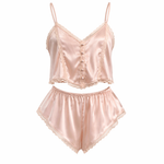 Pink satin lingerie set with lace details on a white background
