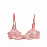 Pink lace bra on a white background