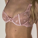 pink lace bra with charm close up