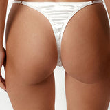 Person wearing a white bikini on a plain background